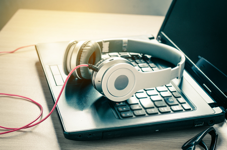 Headphone notebook on a wooden in work roomの写真素材