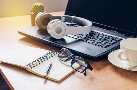 Headphone notebook on a wooden in work roomの写真素材