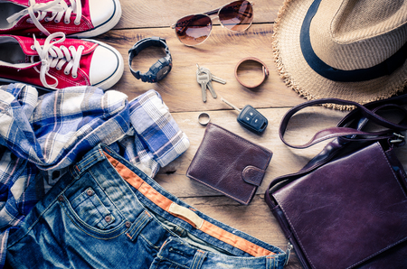 Clothing and accessories for travel on wood backgroundの写真素材