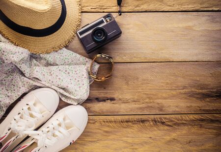 Travel accessories and costume on wooden floorの写真素材