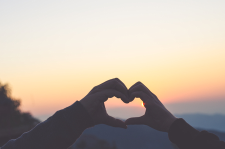 Two hands in shape of love heart. Show love.の写真素材