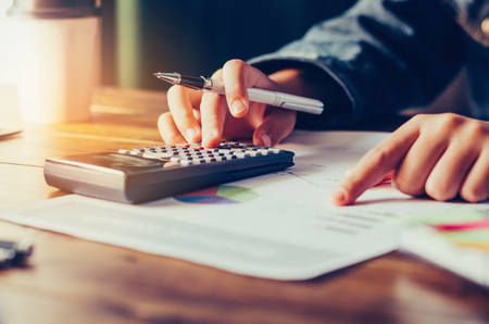 Businessman are working with a calculator and laptop. in office business conceptの写真素材