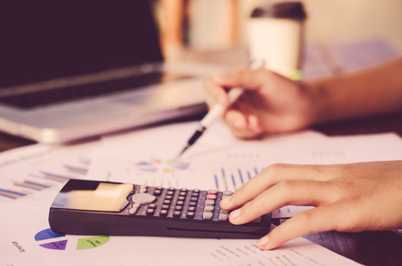 Businessman are working with a calculator and laptop. in office business conceptの写真素材