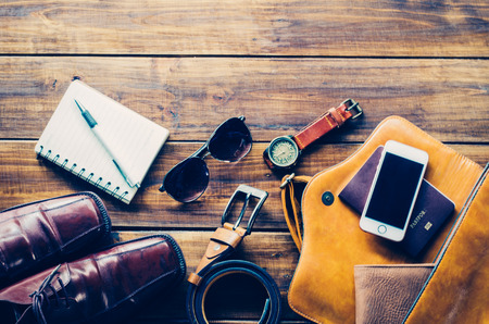 Tourism planning and equipment needed for the trip on wooden floorの写真素材