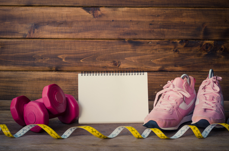 fitness concept with Exercise Equipment on wooden background.の写真素材
