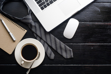 Laptop computer with office accessories on wooden tableの写真素材