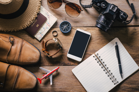 Travel accessories on wooden floor ready for travelの写真素材