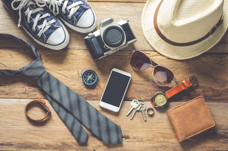 Travel accessories on wooden floor ready for travelの写真素材