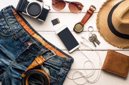 Travel Clothing accessories Apparel along for the trip on white wood floorの写真素材