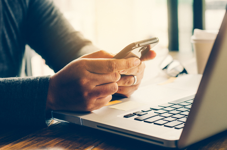 Closeup photo woman business working with new startup for smartphone and laptop の写真素材