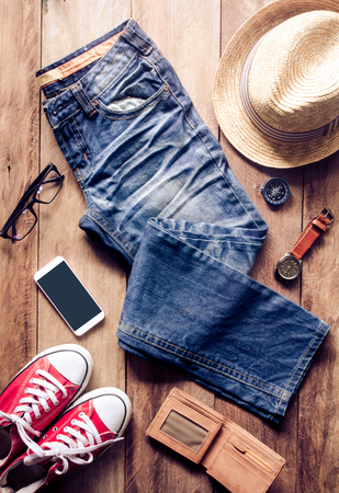 Clothing and accessories for travel on wooden floor - concept lifestyleの写真素材