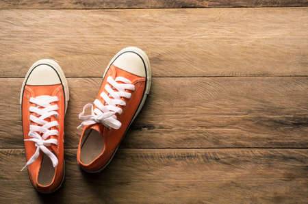 Red sneakers on wooden floors.-lifestyleの写真素材
