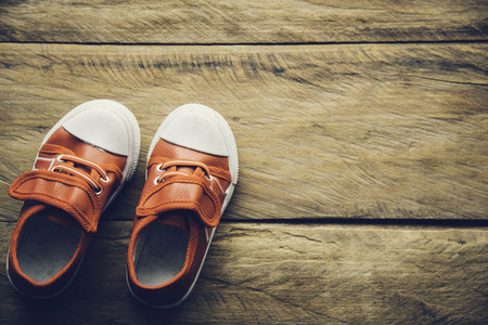 Red shoes for children on wooden floorの写真素材