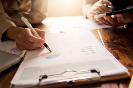 Business people are working on accounts in business analysis with graphs and documentation.の写真素材