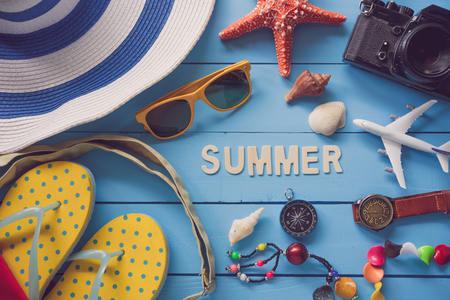 Sea travel accessories A hat, sunglasses, sandals. Placed on blue wooden with word 'SUMMER" の写真素材