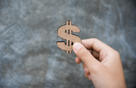 Hand Holding Dollar Signs - Concepts for Earning a Businessの写真素材
