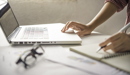 Business woman working on laptop computer in office