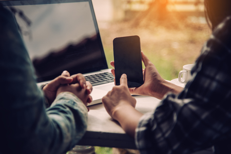 Team businessman's job . working with laptop in open space office. Meeting report in progress. sun glare effectの写真素材