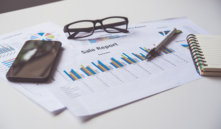 Top view with document pen graph and accounting documents placed on the desk in officeの写真素材