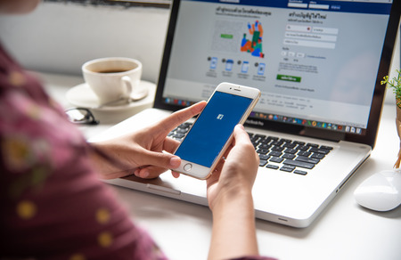 LAMPHUN, THAILAND - July 8, 2018: In a hand for man with social networking service Facebook on the...
