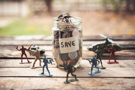 Toy Soldier Dolls are placed around a dozen glasses with coins inside - a concept protecting the...