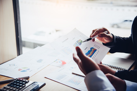 Team businessman job. working with laptop and smartphone in open space office. Meeting report in progressの写真素材