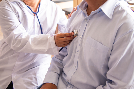 The doctor is listening to the patient's heart.の写真素材