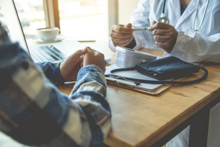 The doctor is discussing with the patient after a physical examination of the results and treatment...