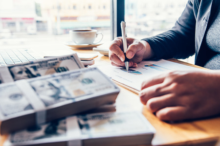 Businessmen are working on dollars, calculating profits and earning results,の写真素材