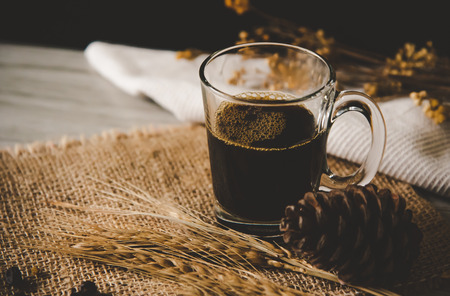 Black coffee in glass is placed on wooden floor - concept still lifeの写真素材