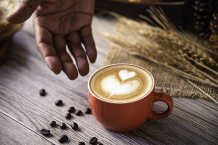 Barista's hands are delivering coffee to customers.