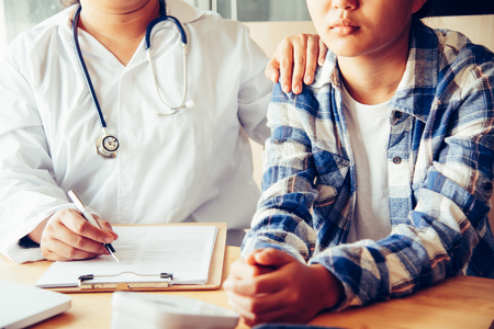 The doctor is discussing with the patient after a physical examination of the results and treatment guidelines.の写真素材