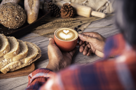 Hand is holding a red cup of coffee. concept still lifeの写真素材
