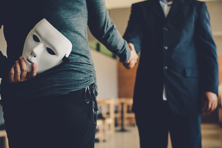 Masked, no sincerity of doing business together.の写真素材