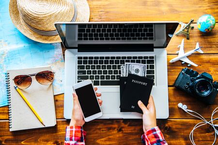 Travelers are planning a trip by searching the route on the map and searching for information on the internet.の写真素材