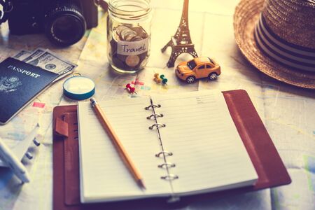 Notebook placed on the map, travel planningの写真素材