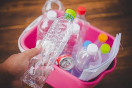 Hands holding bottles for recycling, green conceptの写真素材