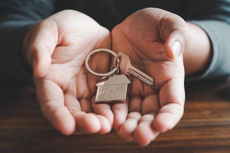 Holding house keys concept, house keys for new house, new house purchaseの写真素材