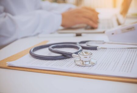 Stethoscope with clipboard on desk,Doctor Recommends Patient, Healthcare and medical concept.の写真素材