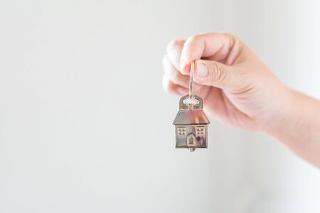 Holding house keys concept, house keys for new house, new house purchaseの写真素材