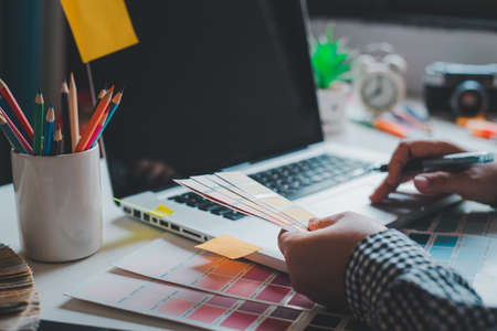 The graphic designer creative team is currently working on the design and color selection on the...