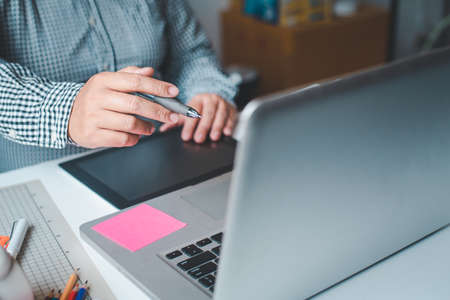 The graphic designer creative team is currently working on the design and color selection on the...