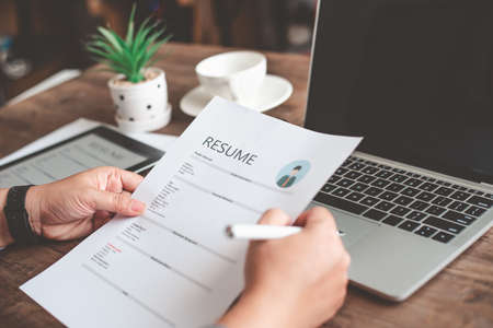 People are reviewing job applications before filling out their resume on the job application form in...