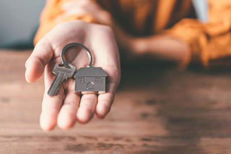 Holding house keys concept, house keys for new house, new house purchaseの写真素材