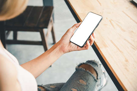 Asian business woman  hand using and touching smart phone with white blank empty screen.