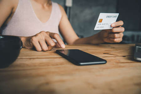 Women's hands holding a credit card and work on laptop Online payment for online shopping