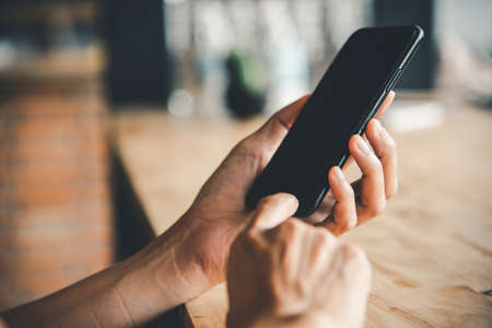 Asian business woman  hand using and touching smart phone with white blank empty screen.