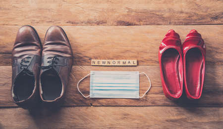 Men and women shoes laid on wooden floors, concept new normal during the epidemic disease covid-19