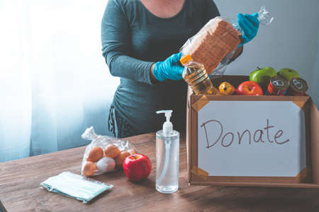 Volunteers with donation boxes for the needy and provide essential supplies to help during the...
