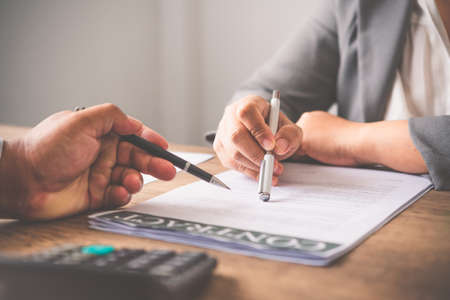 businessman is negotiating, advising, and explaining the matter of the contract to be agreed to sign the contract.の写真素材